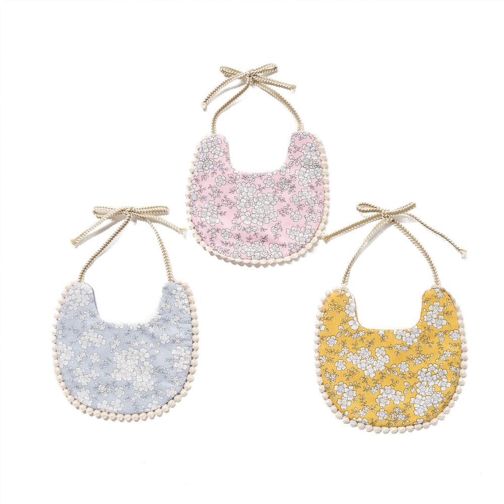 GZMM baby bib on a baby wearing – versatile reversible style for daily wear.
