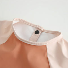 GZMM waterproof bib under tap rinse demonstrates easy cleaning.