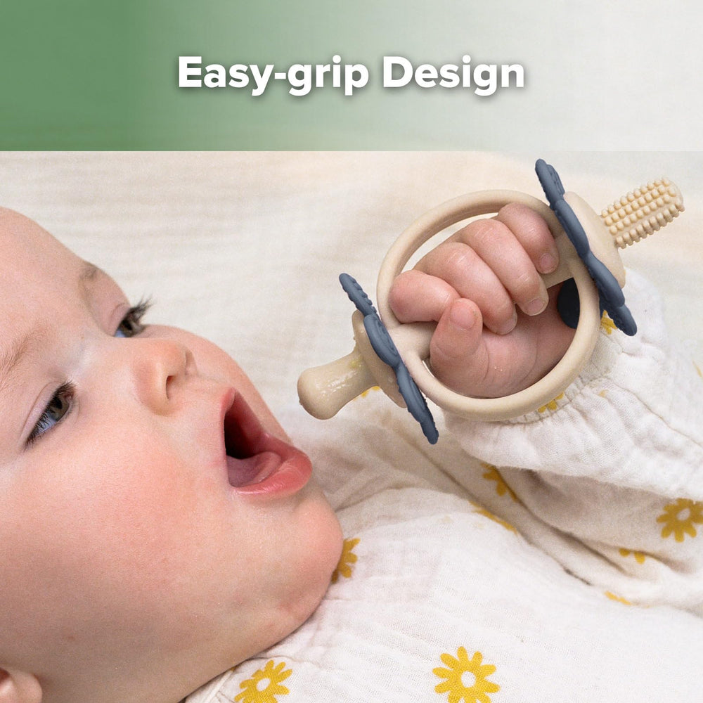 Ergonomic Haakaa teething toy grips tiny hands securely.