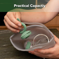 Haakaa On-The-Go steamer bag beside baby bottles showing bottle compatibility