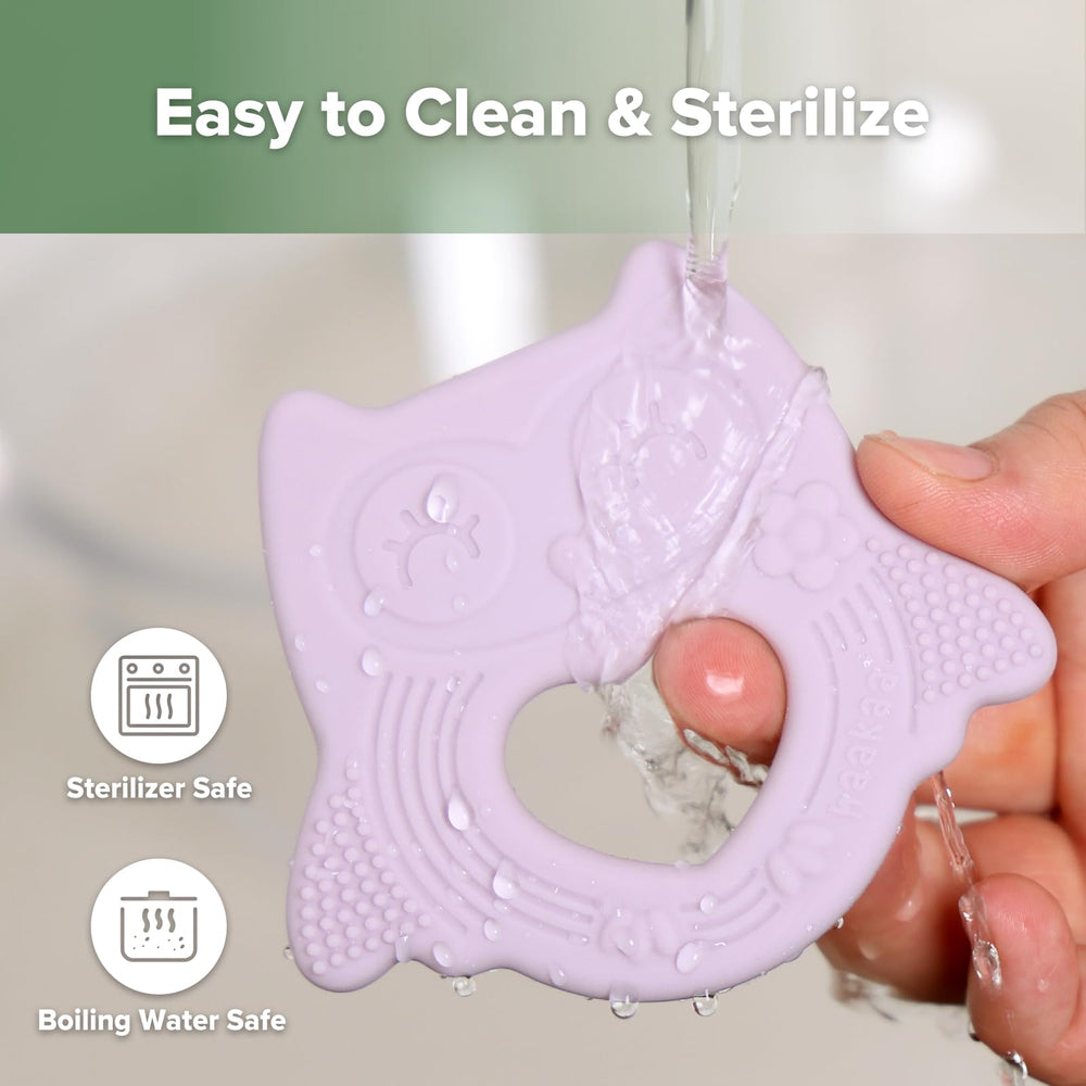 haakaa owl teether baby holding promotes fine motor skill practice.