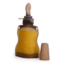 Haakaa silicone baby food spoon with dust cover for clean on-the-go feeding.