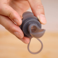 haakaa squeeze feeding spoon showing variable flow opening for age-appropriate feeding