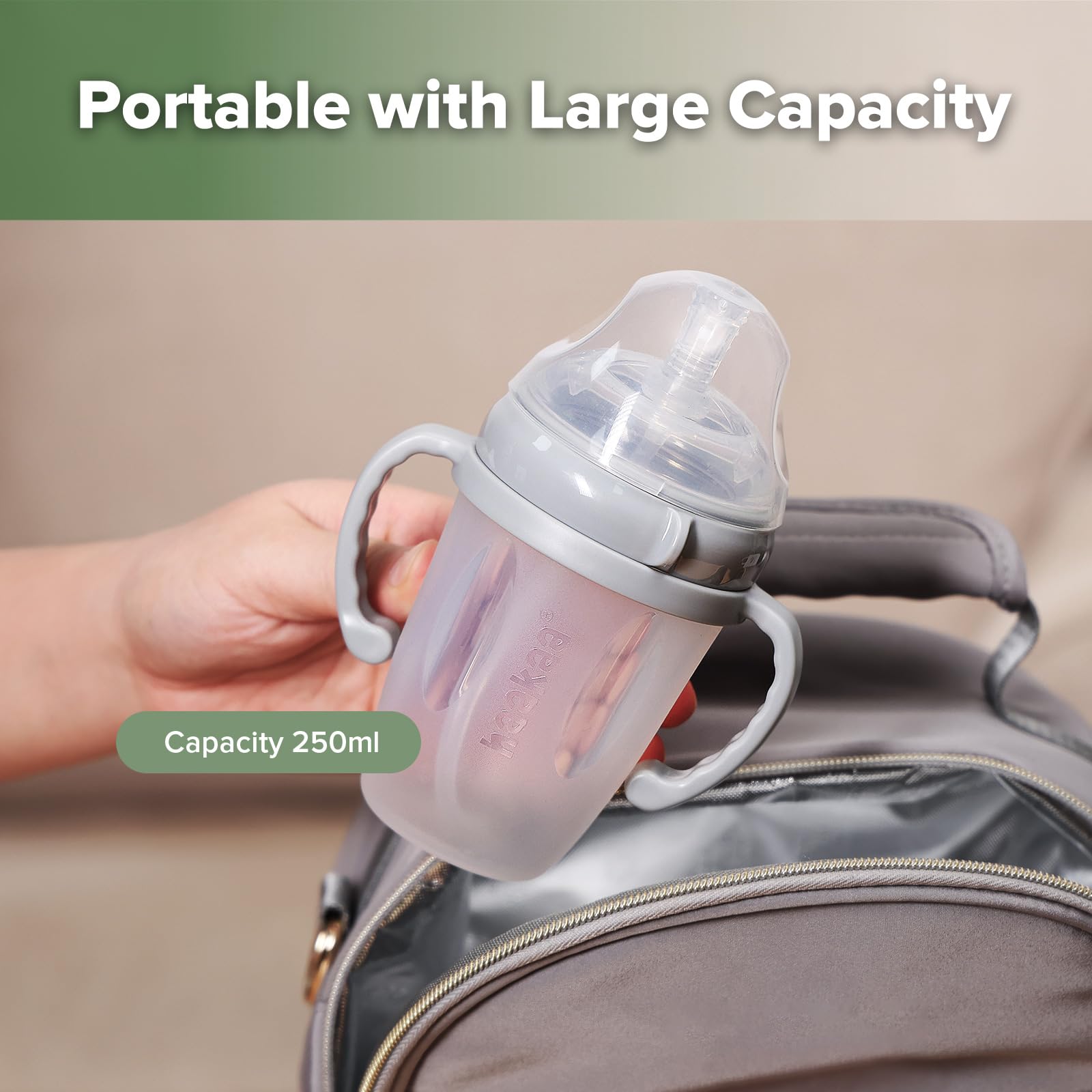 haakaa weighted straw sippy cup grey in-use; supports transition from bottle.