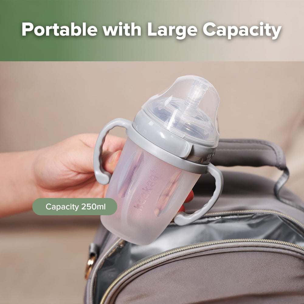 haakaa weighted straw sippy cup grey in-use; supports transition from bottle.