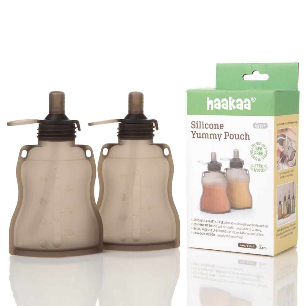 haakaa yummy pouch hand-holding shows easy self-feeding and mess reduction on outings.
