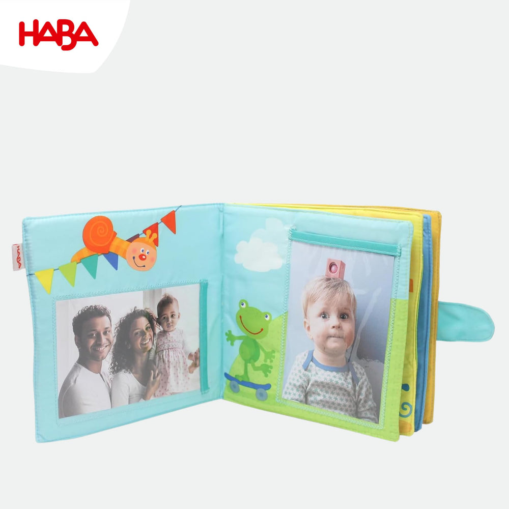 HABA My First Photo Album holds eight 4x6 photos for cherished moments.