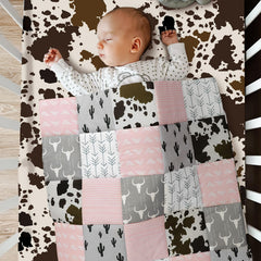 Hahafelt patchwork Western crib room setup showcases pink and gray nursery decor.