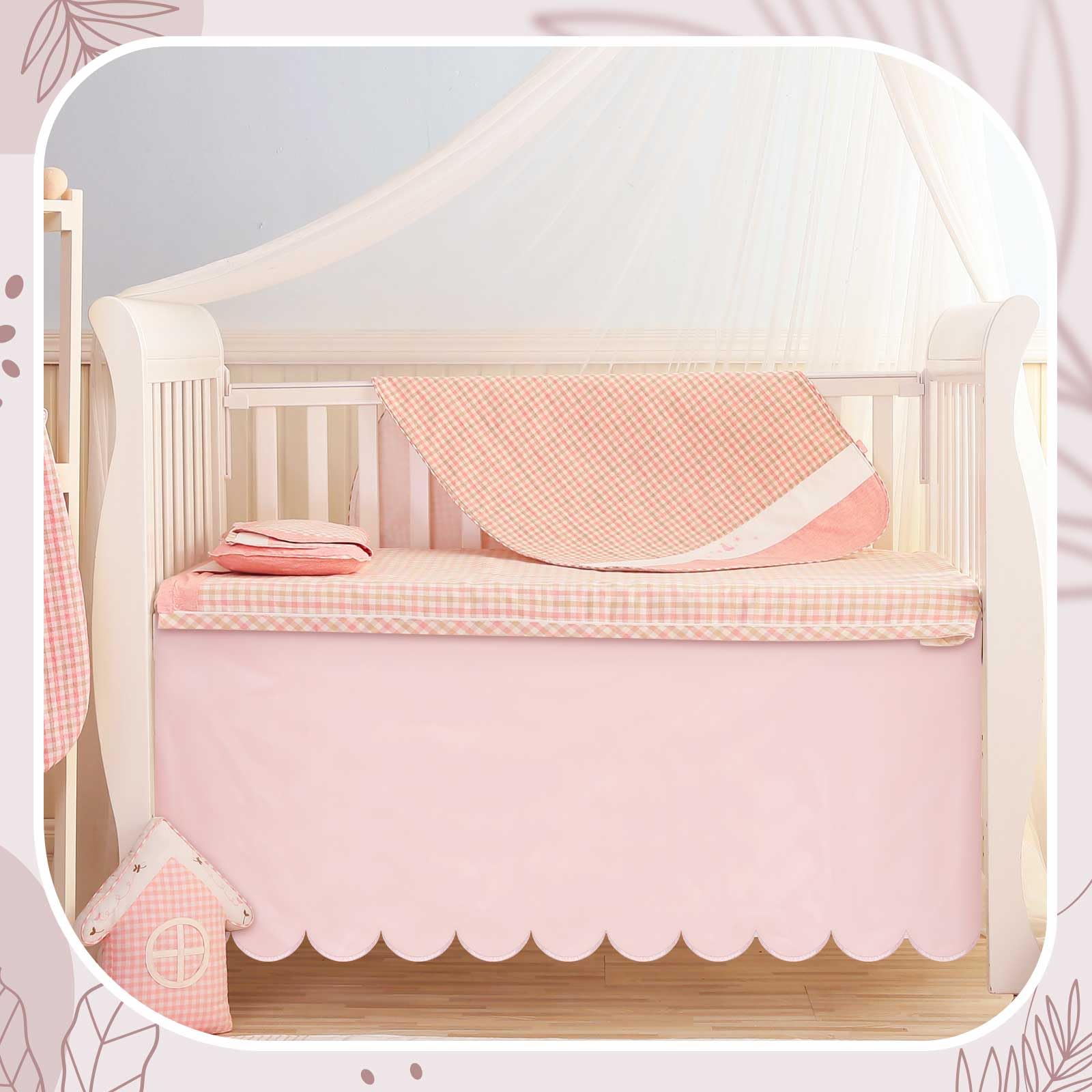 Hahafelt pink scalloped crib skirt in a nursery demonstrates versatile styling.