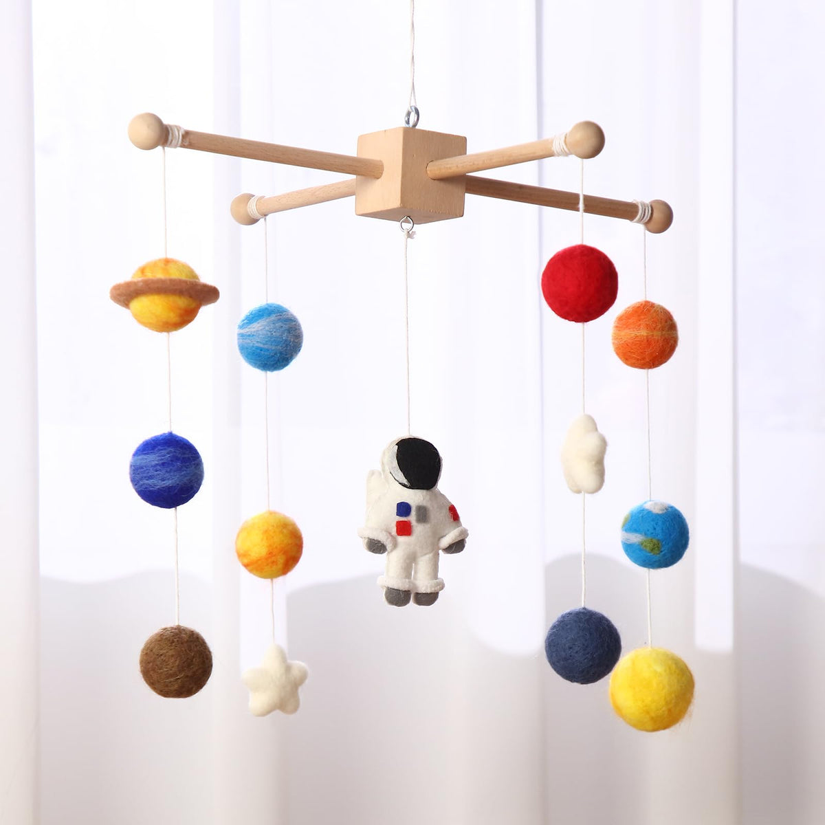 Hahafelt Space Nursery Mobile planet assembly highlights colorful planets for visual stimulation.