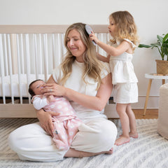 HALO microfleece sleepsack daisy hands-to-face demonstrates flexible 3-way swaddle for growing babies