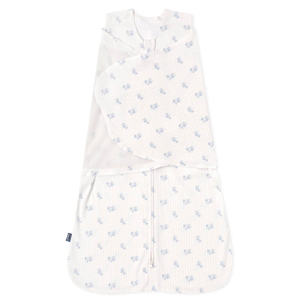 HALO Sleepsack Swaddle Floral Vintage Stripe seen for secure newborn sleep with soft cotton.