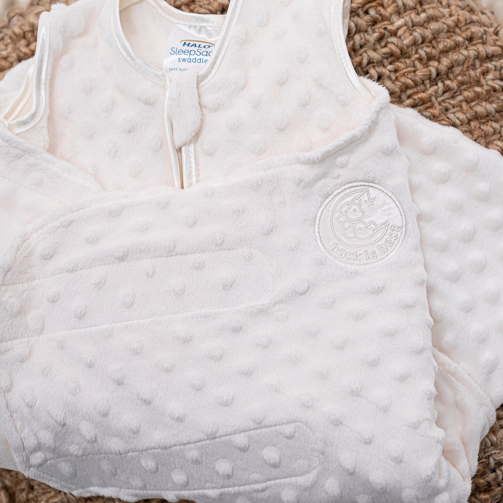 HALO Sleepsack Swaddle velboa dots fabric closeup—soft plush texture supports gentle warmth.