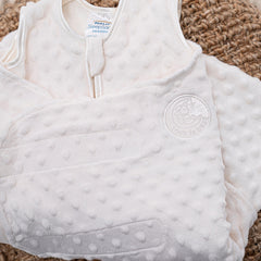 HALO Sleepsack Swaddle velboa dots fabric closeup—soft plush texture supports gentle warmth.