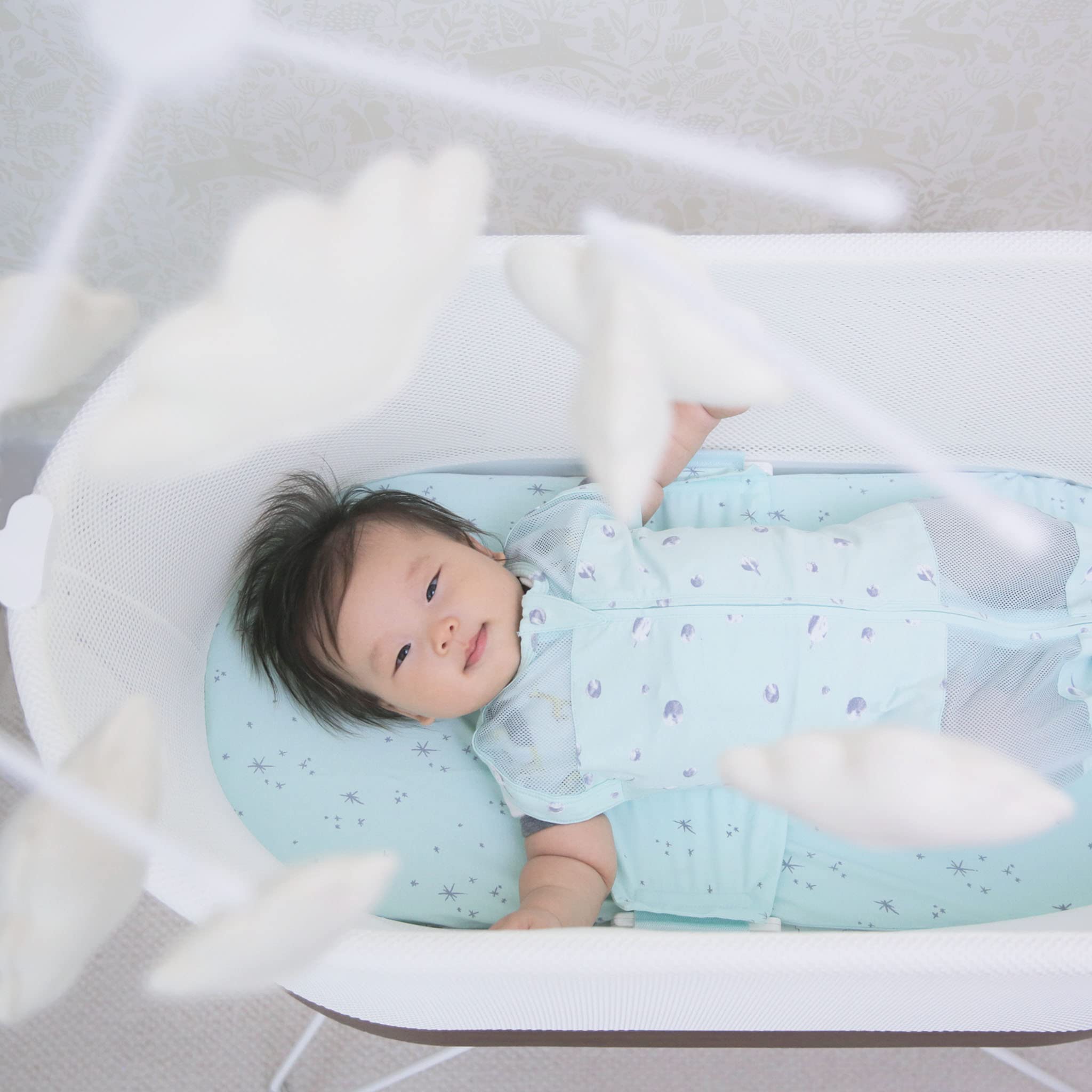Happiest Baby Sky Mobile soft woolen clouds create a calming nursery aesthetic.
