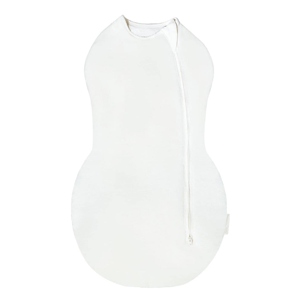 Happiest Baby Sleepea Comforter Swaddle in ivory demonstrates secure wrap for cozy sleep.