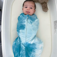 Happiest Baby Sleepea escape-proof Velcro demonstrates secure wrap during nighttime diaper changes.