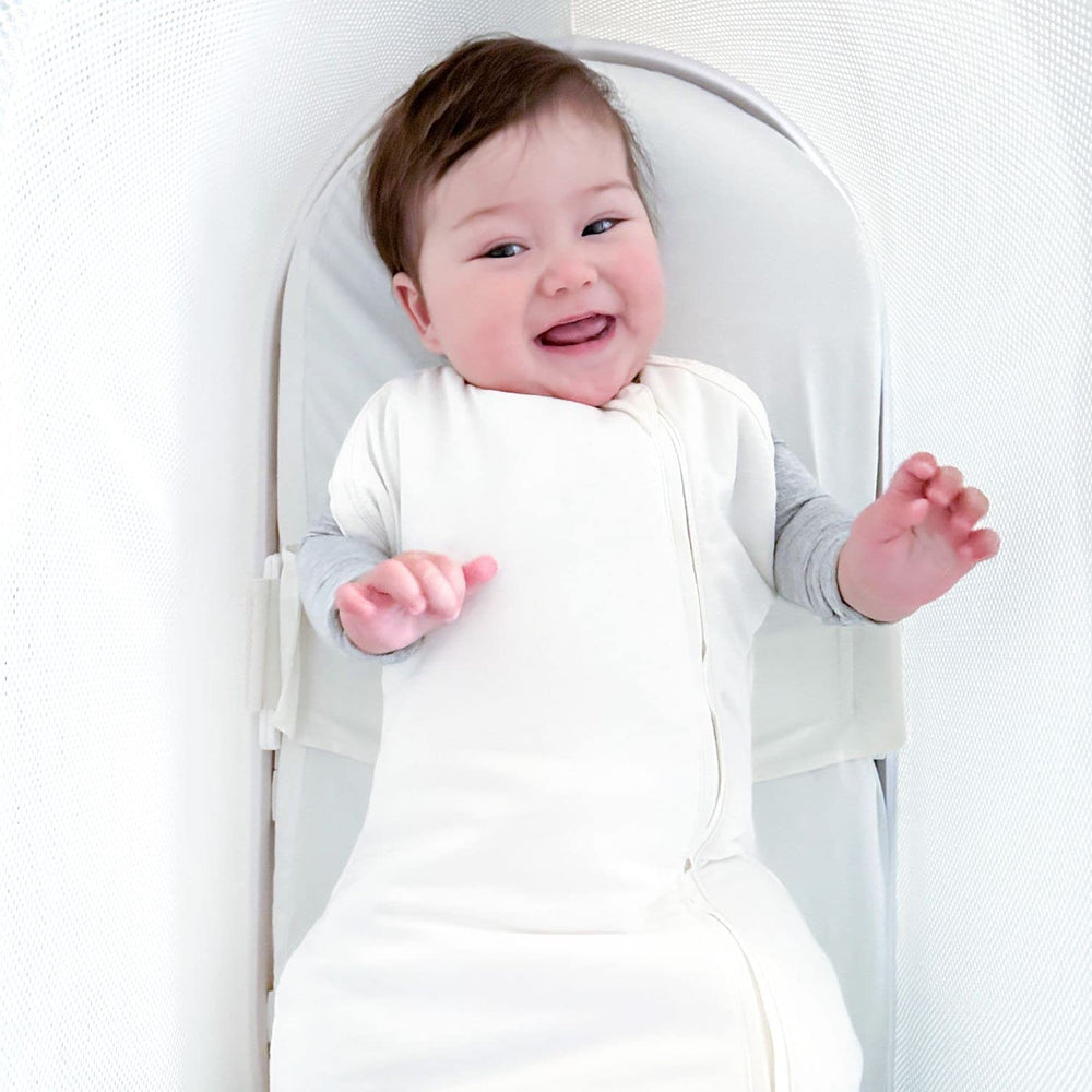 Patented wings secure baby on the back inside SNOO for a stable sleep position.