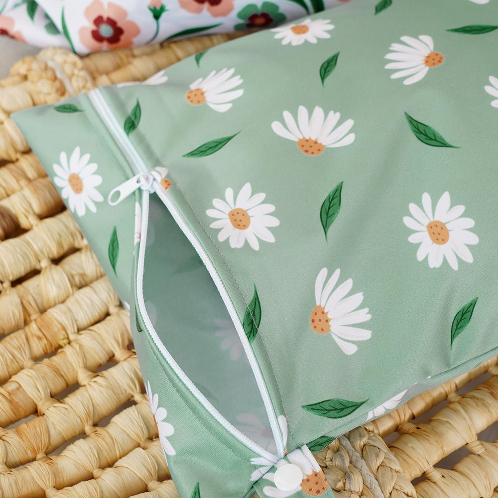 Happy Flute Daisy wet bag hanging on stroller illustrating hands-free transport