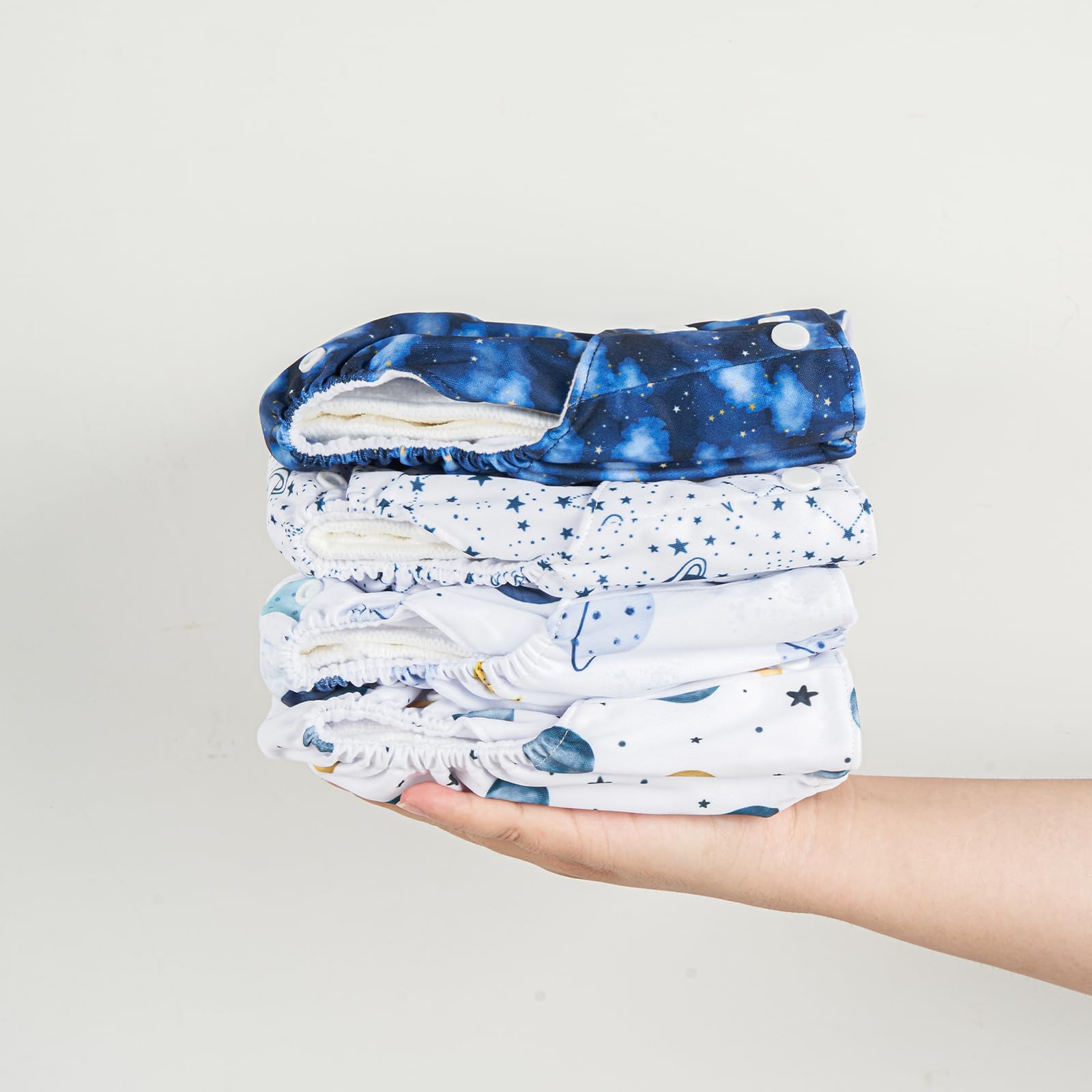 HappyFlute baby wearing pocket diaper set in breathable fabric for comfort.