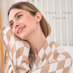 HardNok Checkered Muslin Throw layered on a bed for extra warmth and style.