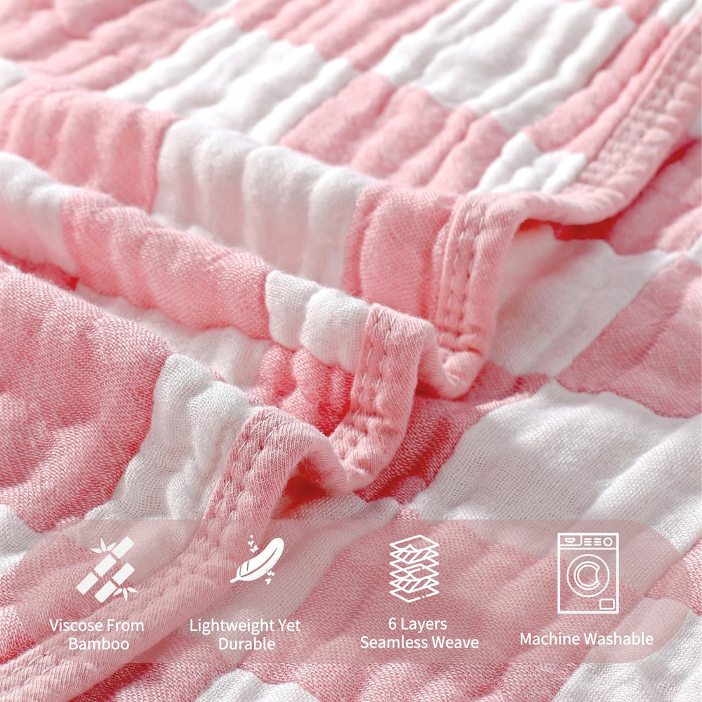 HardNok pink checkered muslin blanket in crib scene shows growth-ready versatility