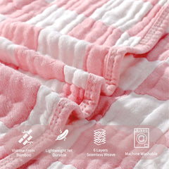 HardNok pink checkered muslin blanket in crib scene shows growth-ready versatility