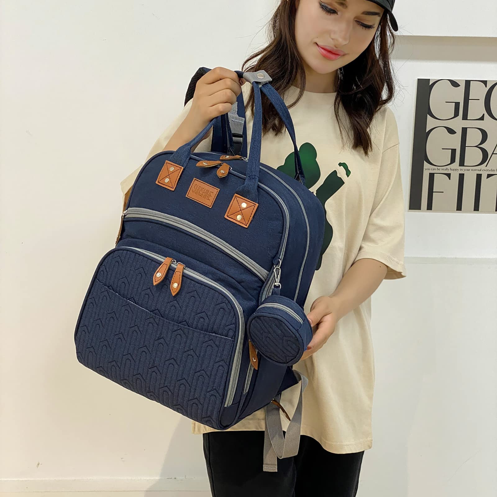 Stroller buckles on Heegel diaper bag backpack for hands-free travel