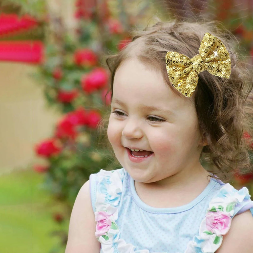 HELYKAKA gold sequins hair bows on alligator clip with secure grip for active daily wear.
