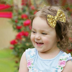 HELYKAKA gold sequins hair bows on alligator clip with secure grip for active daily wear.