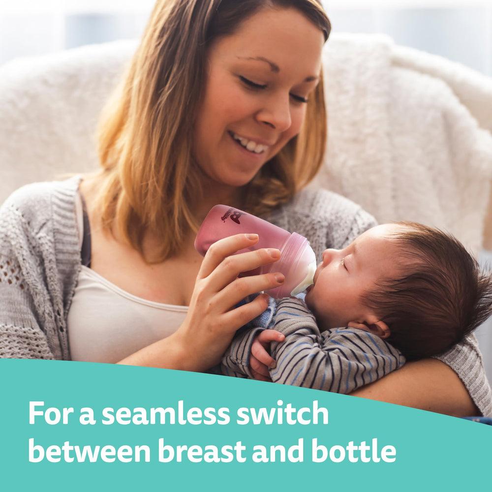 Herobility bottle in use during feeding with rosy colorway