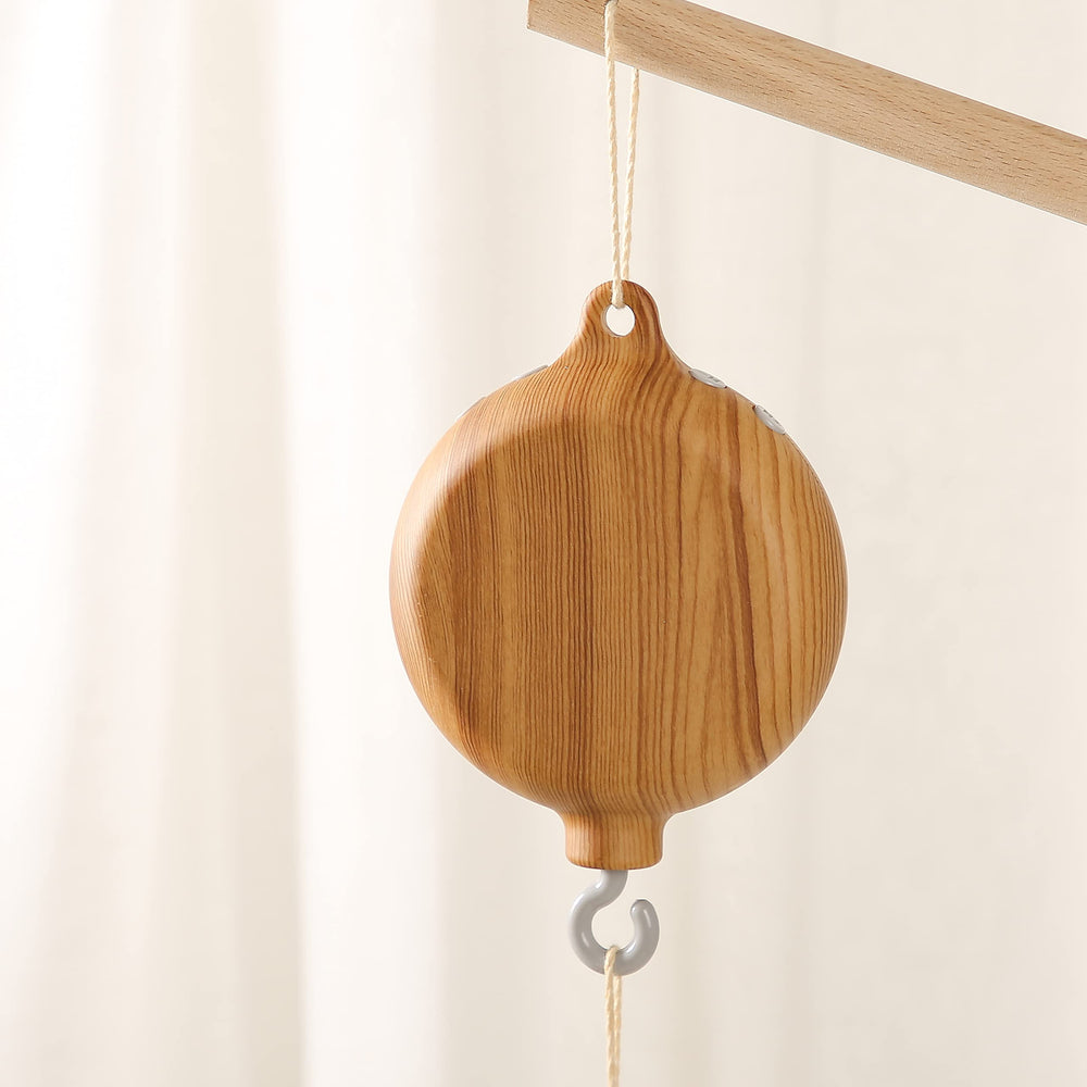 HI BABY MONMENT imitation wood spinner adds a warm nursery aesthetic for calm moments.