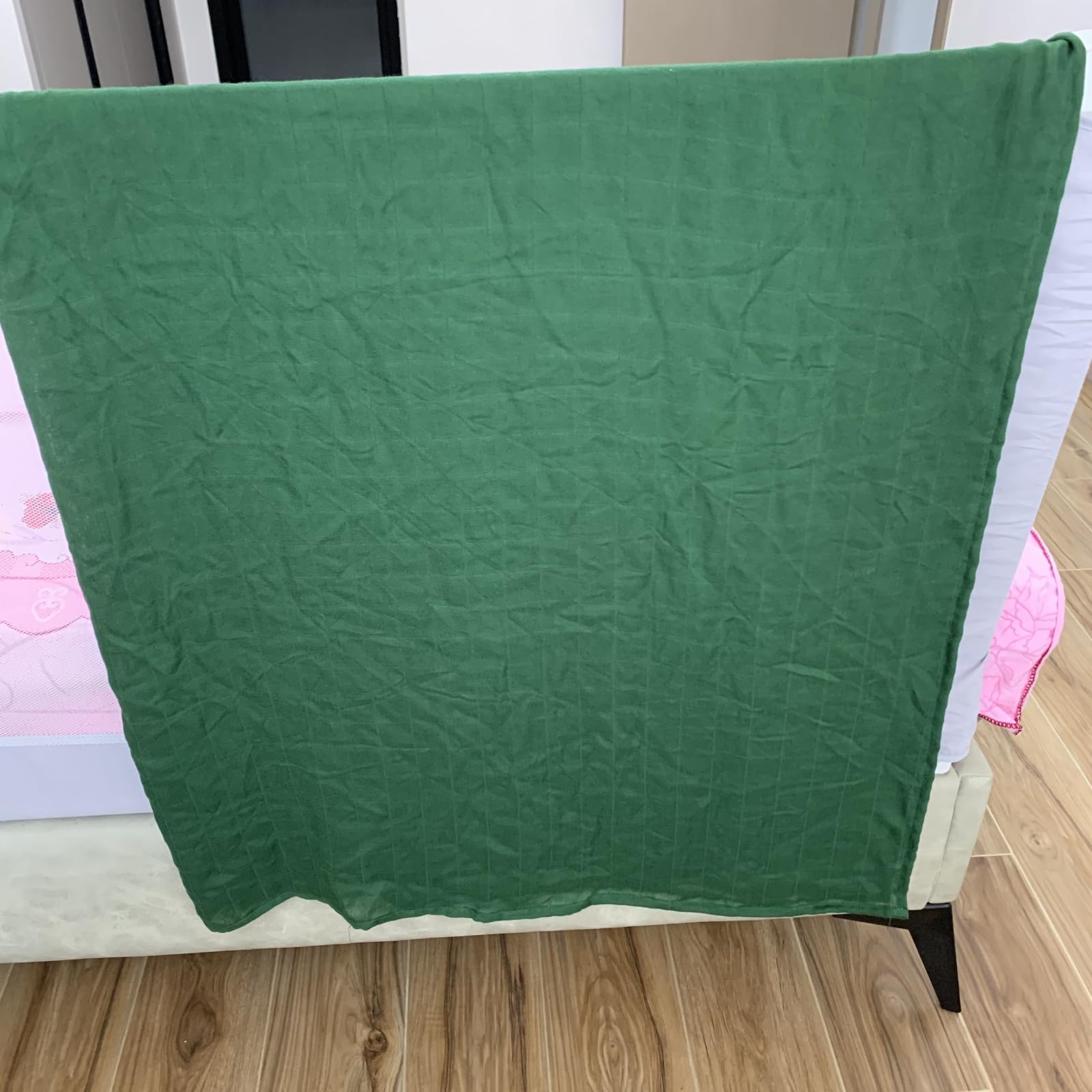 Hollyoo muslin swaddle blanket green wrapped baby demonstrates snug, secure swaddle