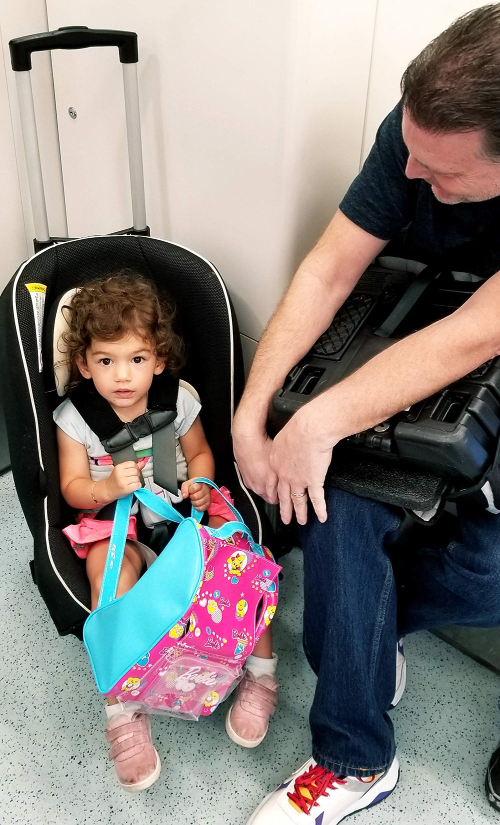 Holm airport car seat roller stored under overhead compartment during flight