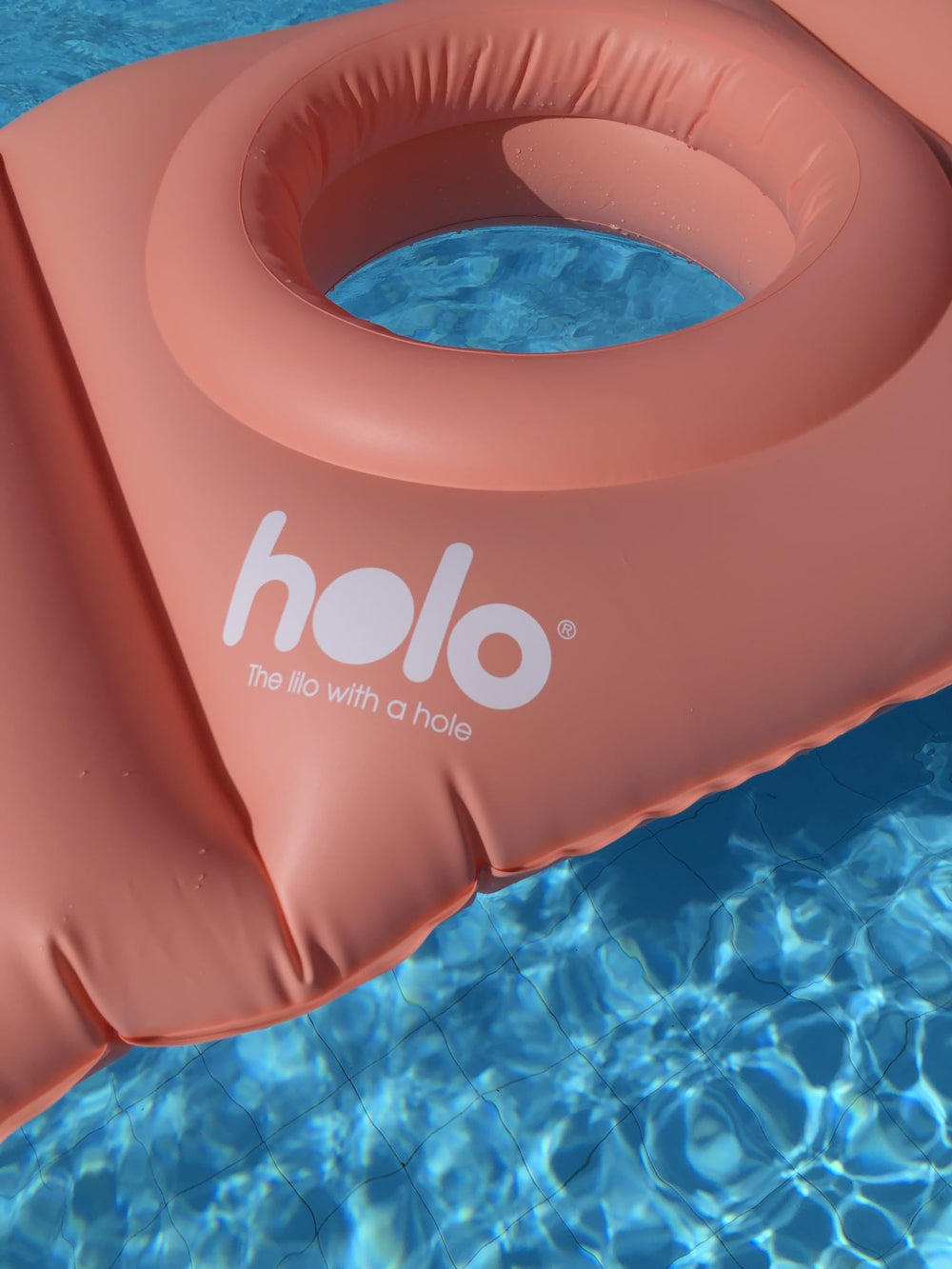 HOLO pillow used for beach relaxation and babymoon comfort during pregnancy.