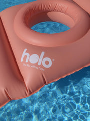 HOLO pillow used for beach relaxation and babymoon comfort during pregnancy.