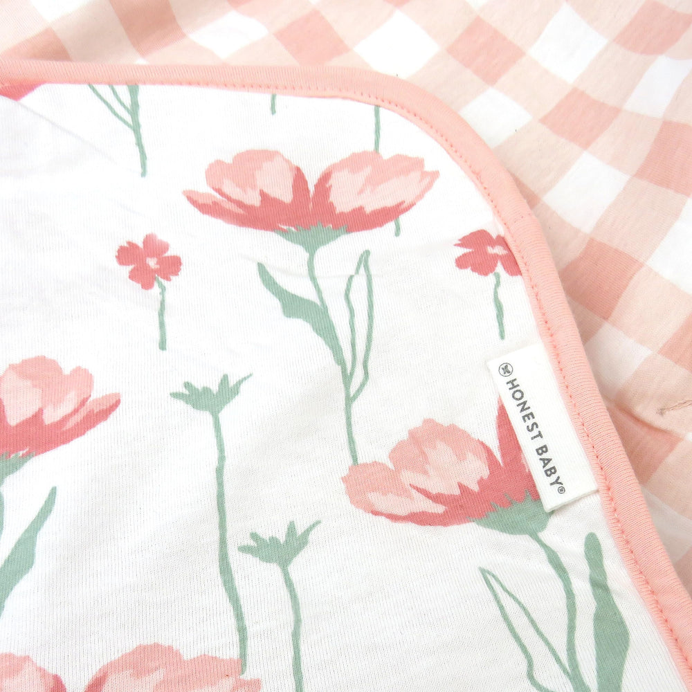 HonestBaby blanket draped in nursery adds a stylish cozy decor element.