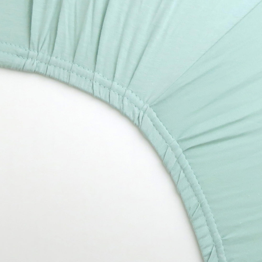 HonestBaby sage crib sheet folded for display shows soft texture and quality.