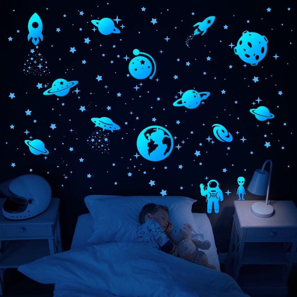 Honeyjoy star-moon-stickers-blue-wall create a dreamy space scene on bedroom walls.
