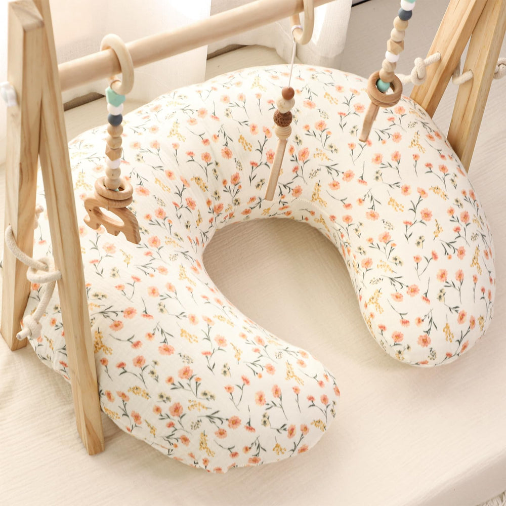 Hooyax muslin nursing pillow cover pink floral on cot demonstrates standard nursing pillow fit