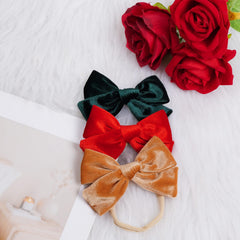 Hoyuwak velvet bows color options in white red green for Christmas outfits.