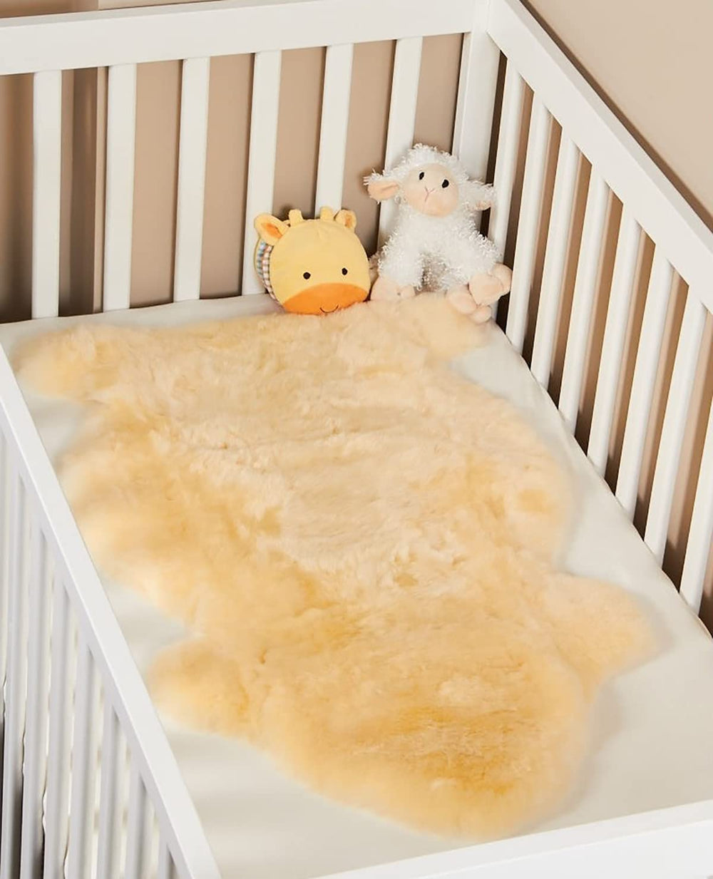 HUAHOO Premium Baby Sheepskin Rug on crib edge providing soft surface for baby play