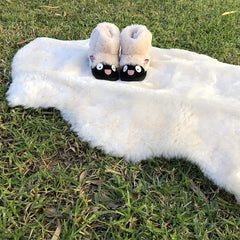 HUAHOO lambskin rug on a play mat provides a gentle surface for tummy time.
