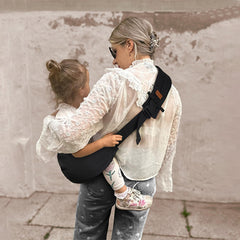 Huefain baby sling beige side-carry highlights hands-free exploration with close, secure bonding.