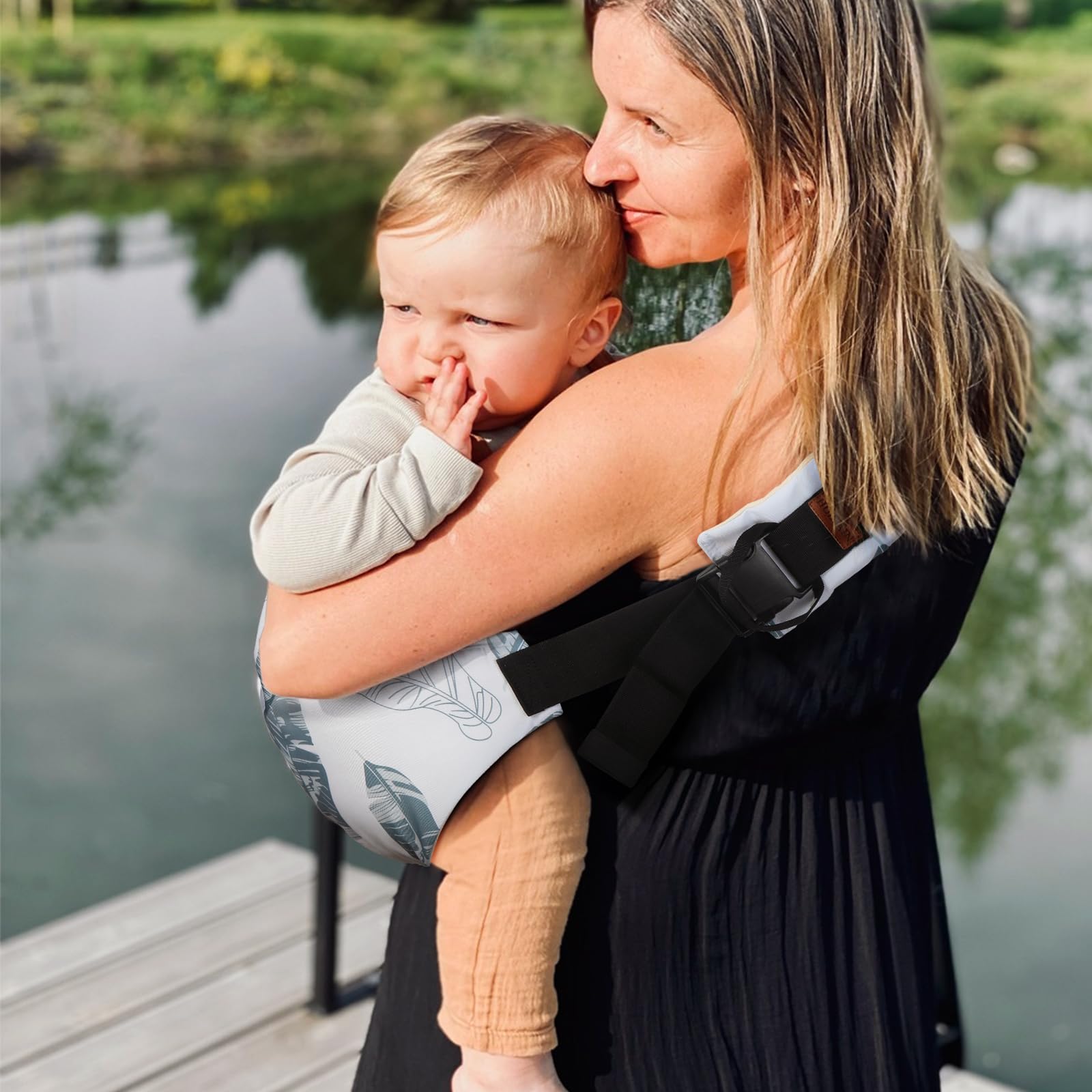 Huefain lightweight travel-friendly sling folded beside a diaper bag.