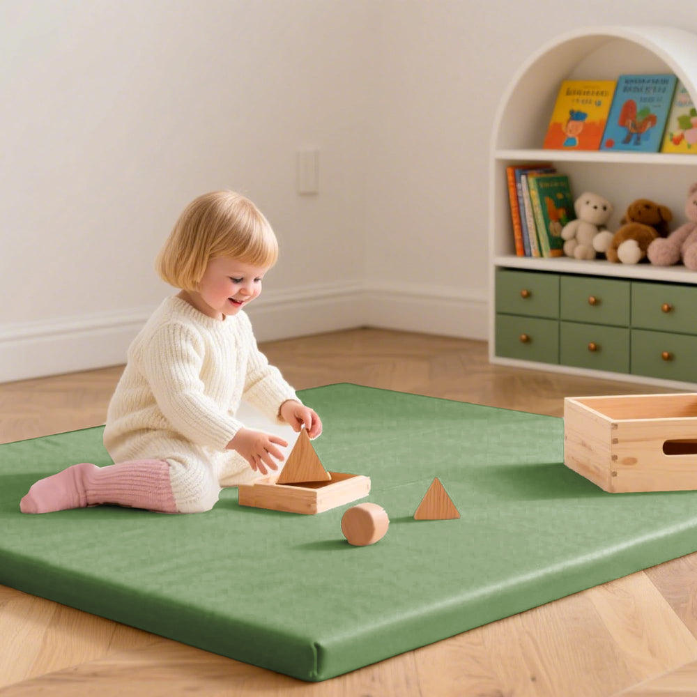 Huloo Sleep mat in green being used during playtime for a safe, cushioned area.