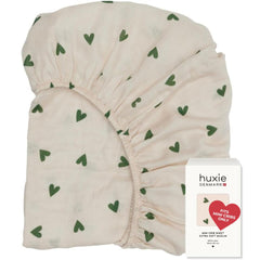 Huxie 24x38 mini crib sheet closeup shows soft texture for baby comfort.