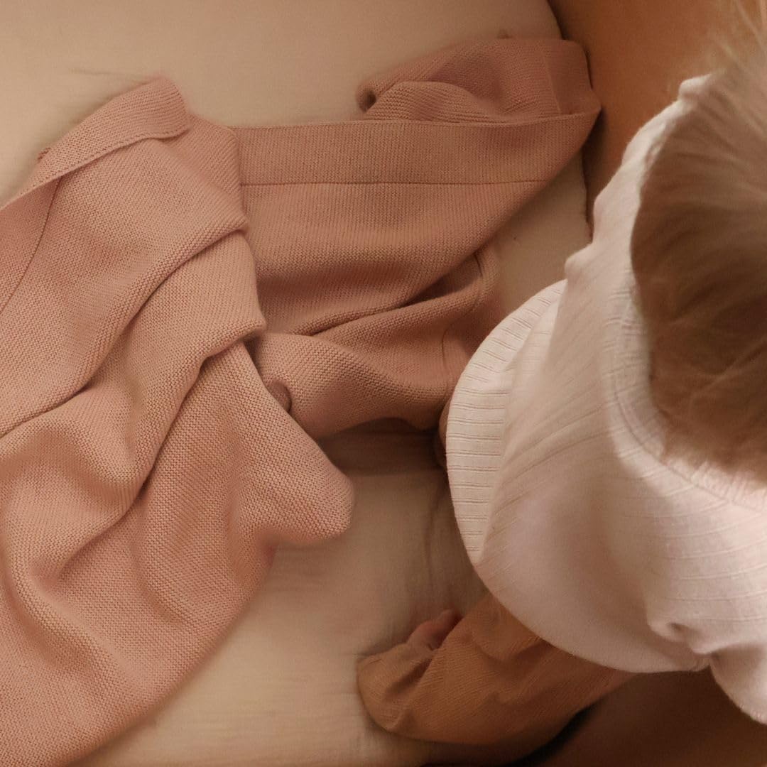 Huxie blanket in car seat during travel, soft and compact.
