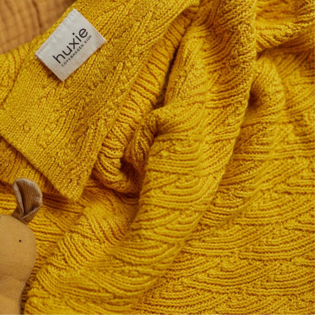 Huxie blanket neatly folded to showcase durable packaging