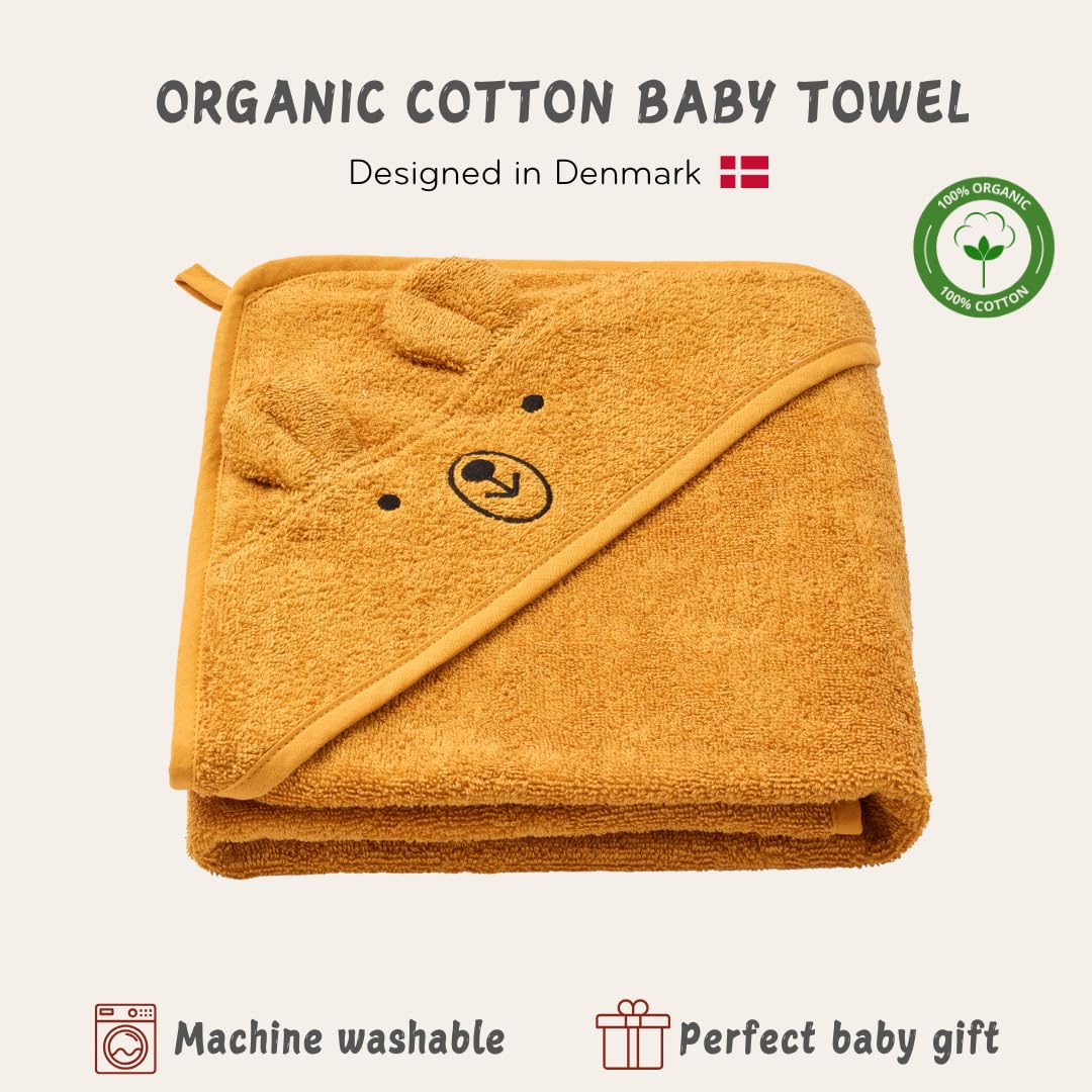 Baby wearing the hood demonstrates cozy wrap with Huxie hooded towel.
